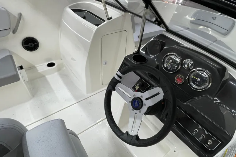 Slide: The Image of 2026 Bayliner VR4 Bowrider OB cockpit with steering wheel and dashboard controls. - 8