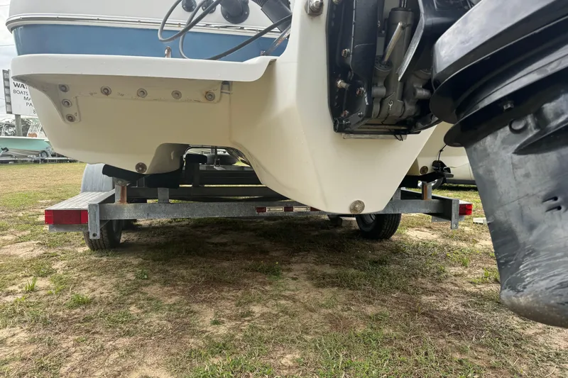 Slide: The Image of 2012 Splendor 259 SUNSTAR boat on trailer, showing underside and motor. - 11