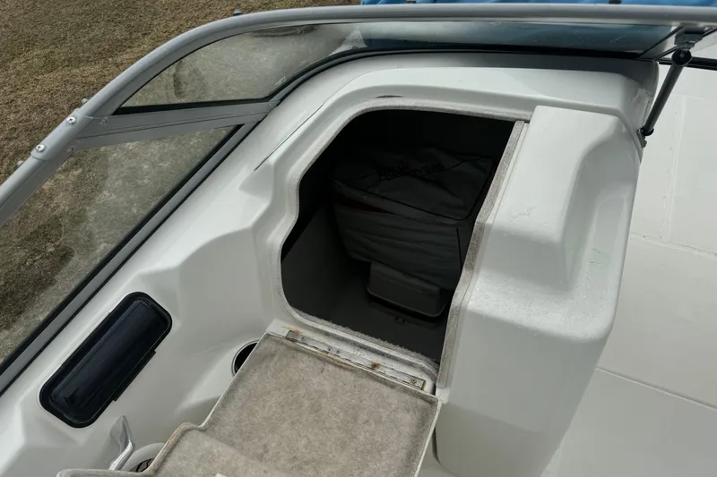 Slide: The Image of 2012 Splendor 259 SUNSTAR boat interior storage compartment with open hatch. - 8