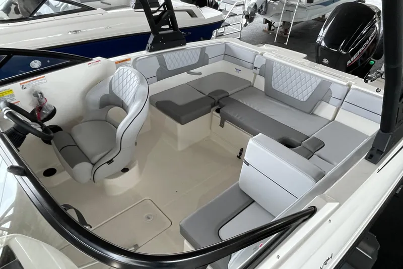 Slide: The Image of 2026 Bayliner VR4 Bowrider OB interior with gray seating and steering wheel. - 10