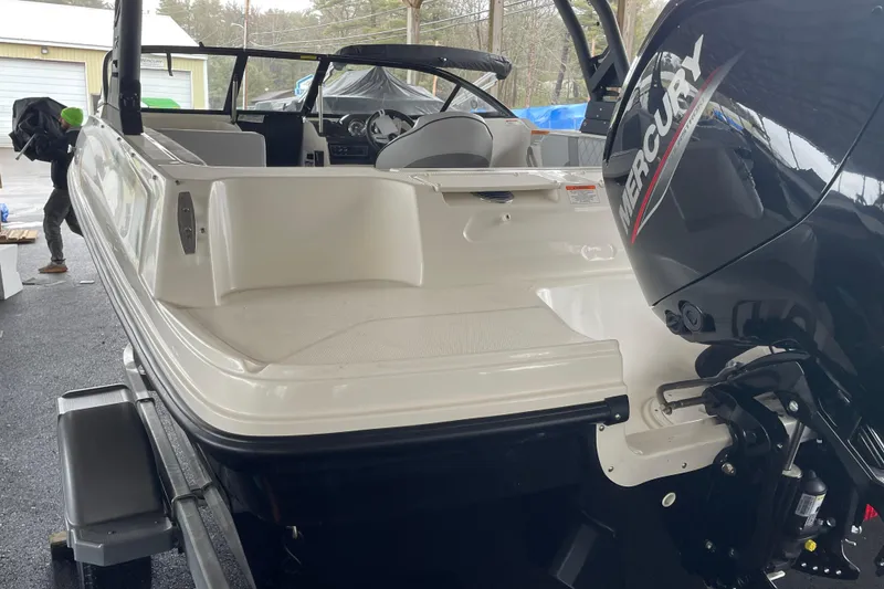 Slide: The Image of 2026 Bayliner VR4 Bowrider OB with Mercury outboard engine, parked on a trailer. - 2