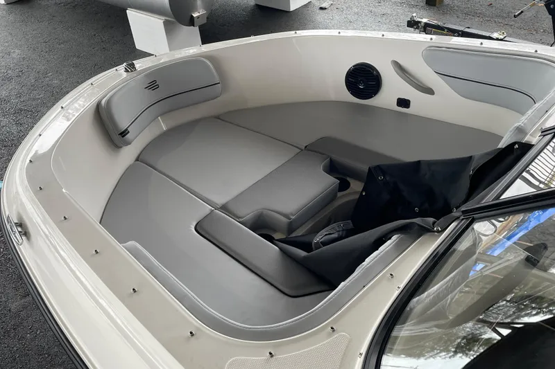 Slide: The Image of 2026 Bayliner VR4 Bowrider OB interior with gray seating and speaker detail. - 4