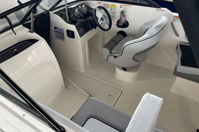 Slide: The Image of 2026 Bayliner VR4 Bowrider OB interior with steering wheel and seating. - 5