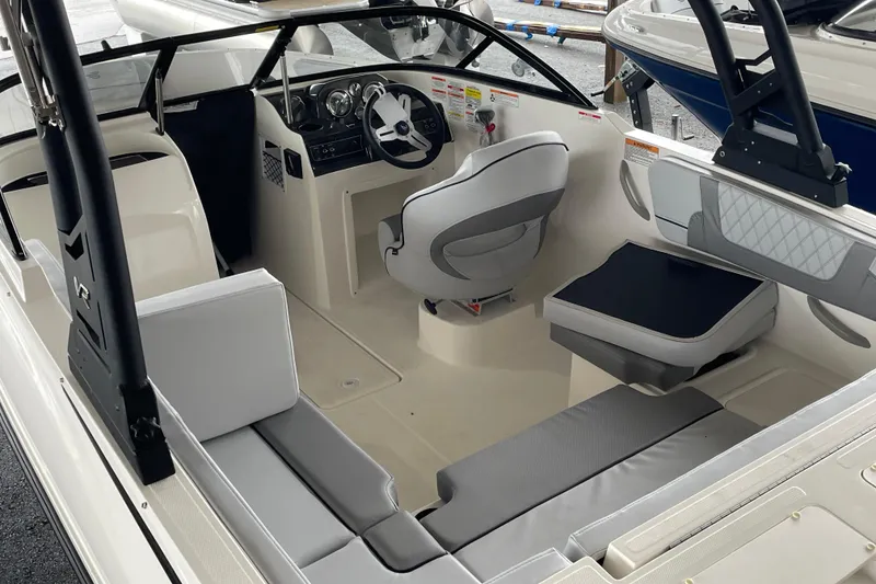 Slide: The Image of 2026 Bayliner VR4 Bowrider OB interior with modern seating and steering console. - 7