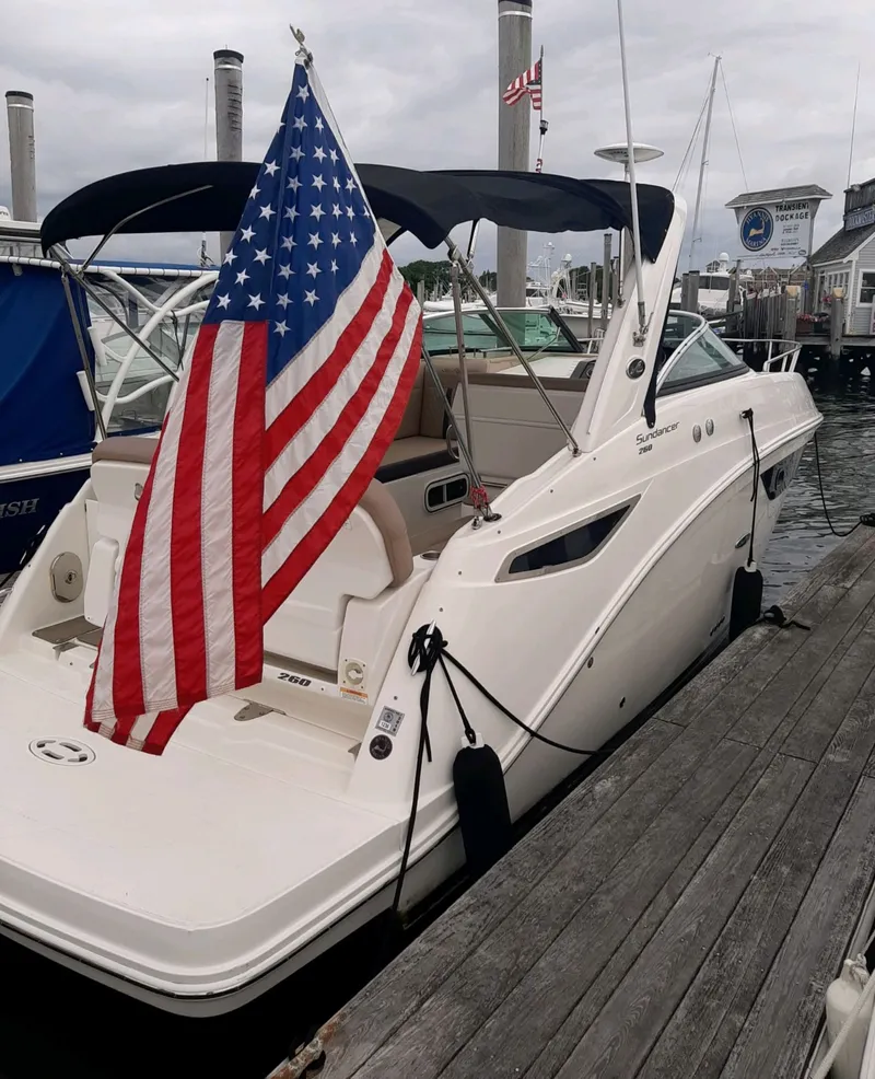 Slide: The Image of 2016 Sea Ray 260 Sundancer with American flag at dock. - 6