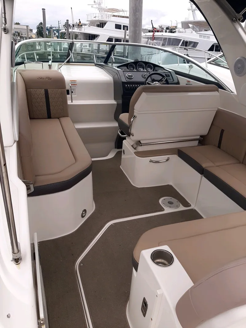 Slide: The Image of Interior of a 2016 Sea Ray 260 Sundancer with beige seating. - 8