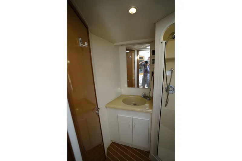 Slide: The Image of Bathroom interior of 1998 Viking Open Express 43 yacht, featuring sink and shower. - 11