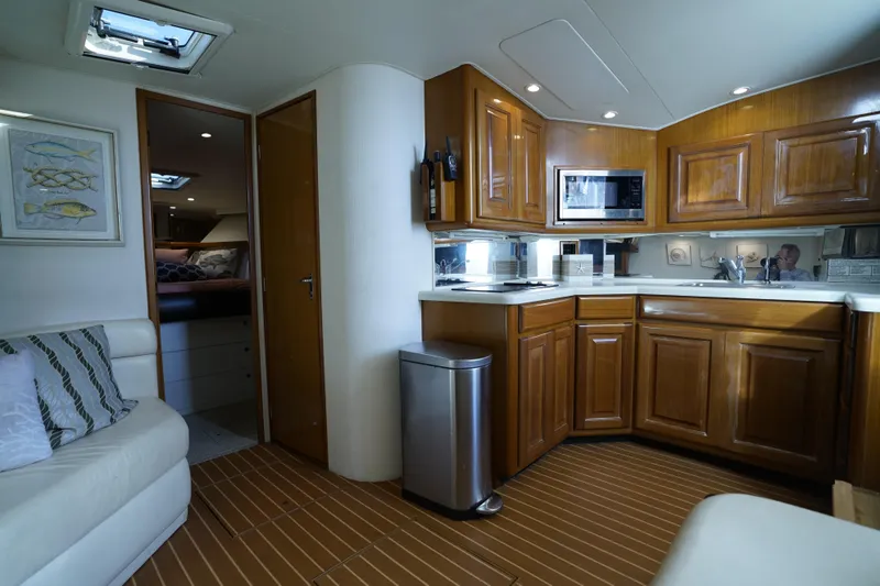 Slide: The Image of Interior of 1998 Viking Open Express 43 yacht with wooden cabinetry and modern amenities. - 12