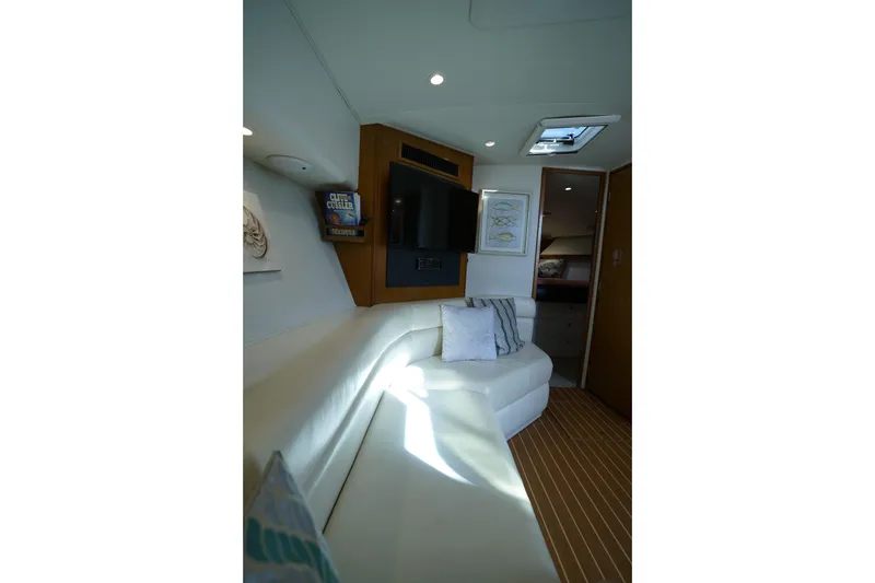 Slide: The Image of Interior of 1998 Viking Open Express 43 yacht with white seating and wooden accents. - 13