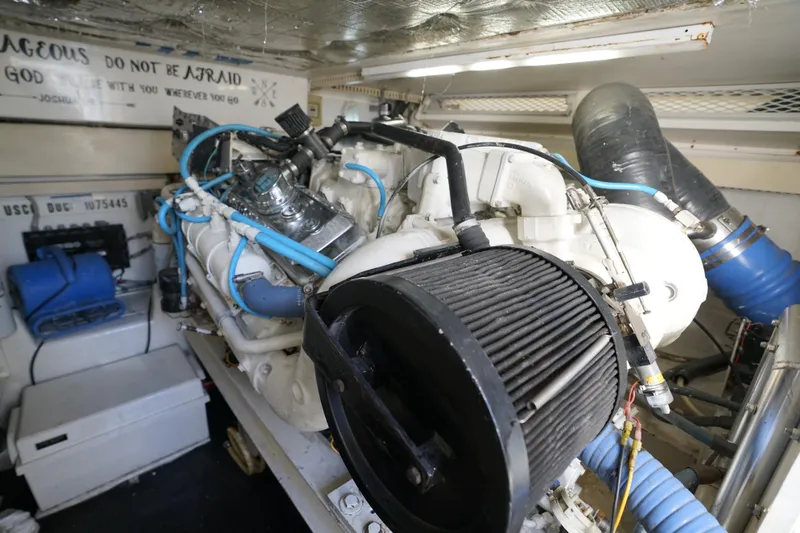 Slide: The Image of Engine room of a 1998 Viking Open Express 43 boat, showcasing machinery and components. - 18