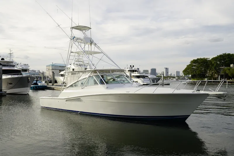 Slide: The Image of 1998 Viking 43 yacht docked in harbor, surrounded by other boats. - 3