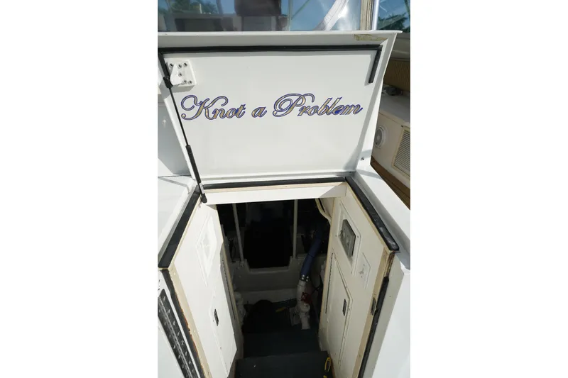 Slide: The Image of 1998 Viking Open Express 43 boat entrance with "Knot a Problem" sign. - 5