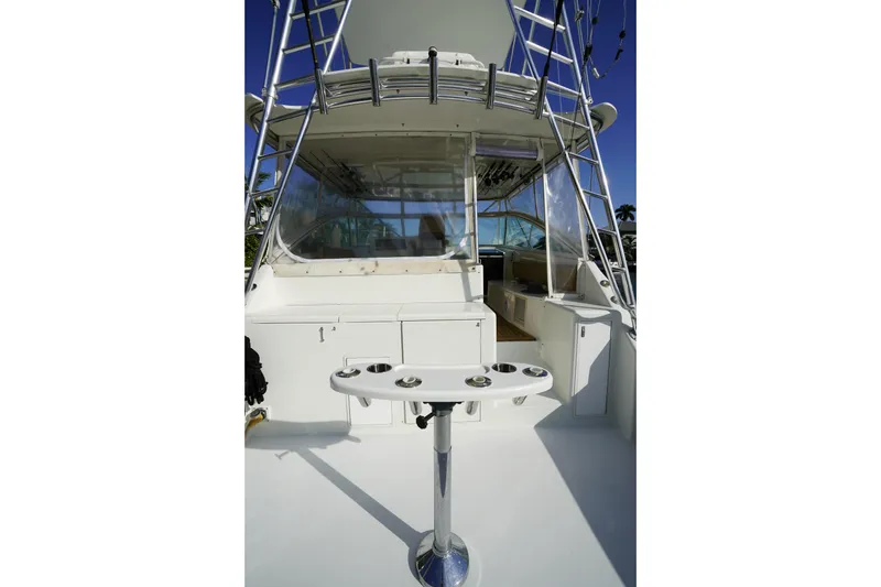 Slide: The Image of 1998 Viking Open Express 43 boat interior with fishing rod holders and seating area. - 6