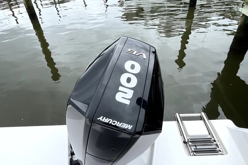 Slide: The Image of 2024 Aquasport 2200 Dual Console with Mercury 200 HP outboard engine on water. - 10