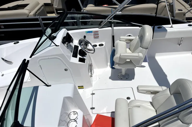 Slide: The Image of 2024 Aquasport 2200 Dual Console boat interior with steering wheel and seating. - 4