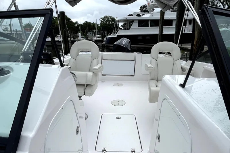 Slide: The Image of 2024 Aquasport 2200 Dual Console boat interior with white seating and open deck. - 7
