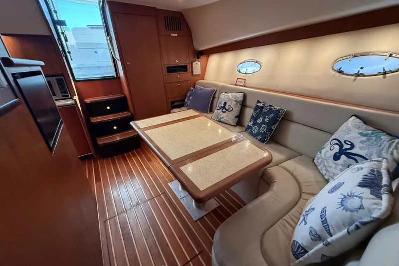 Slide: The Image of Luxurious interior of 2004 Tiara Yachts 4200 Open with elegant seating and nautical decor. - 10