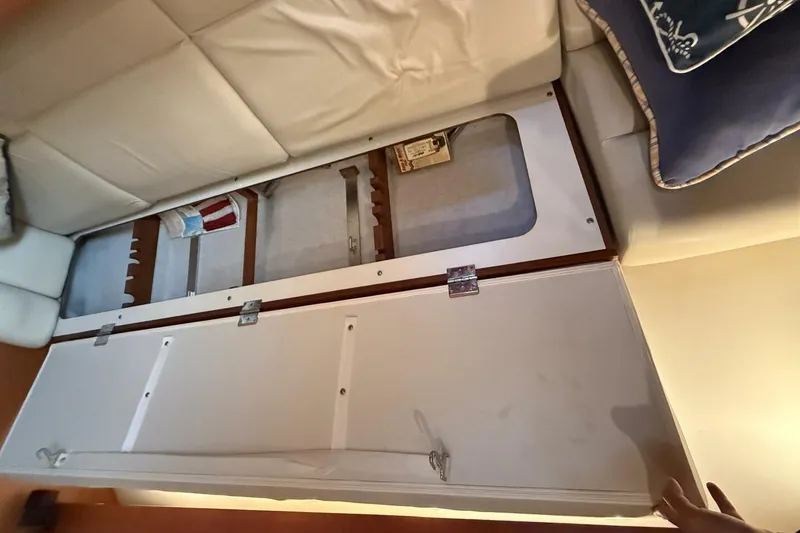 Slide: The Image of 2004 Tiara Yachts 4200 Open interior storage compartment under seating. - 11