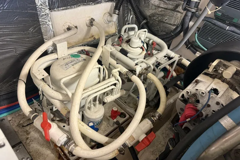 Slide: The Image of Engine room of a 2004 Tiara Yachts 4200 Open, showcasing complex piping and machinery. - 15
