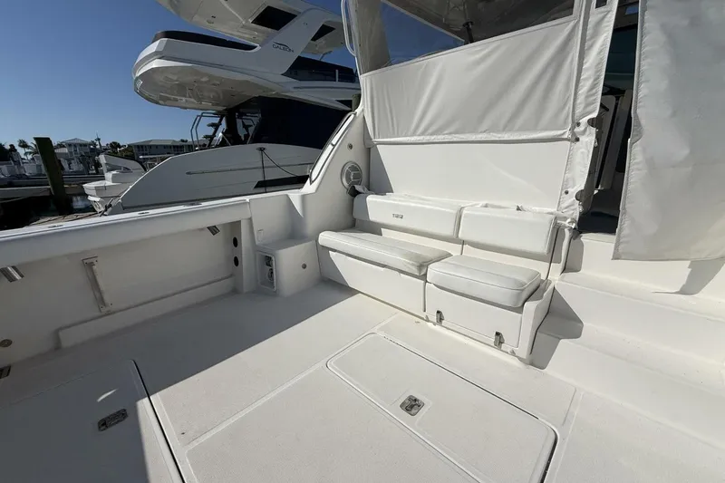 Slide: The Image of 2004 Tiara Yachts 4200 Open cockpit with white seating and clean deck. - 21