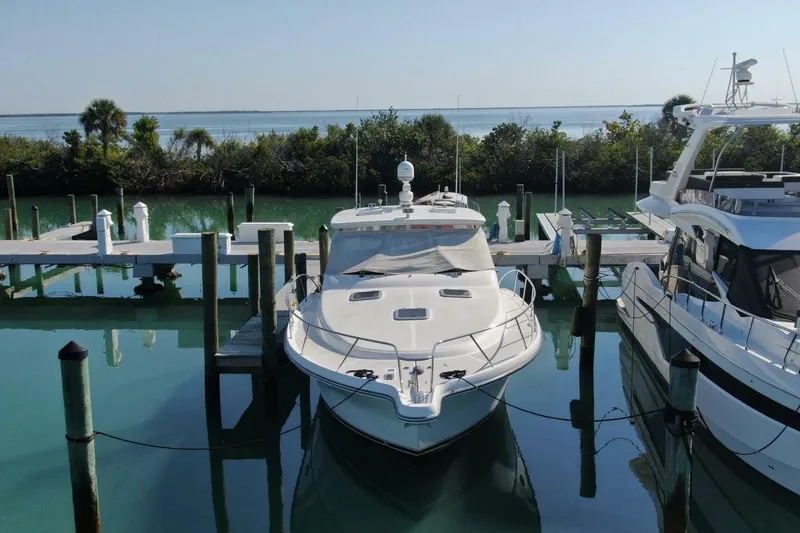 Slide: The Image of 2004 Tiara Yachts 4200 Open docked at marina with scenic water view. - 22
