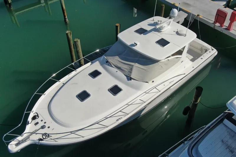 Slide: The Image of 2004 Tiara Yachts 4200 Open docked in calm marina waters. - 23