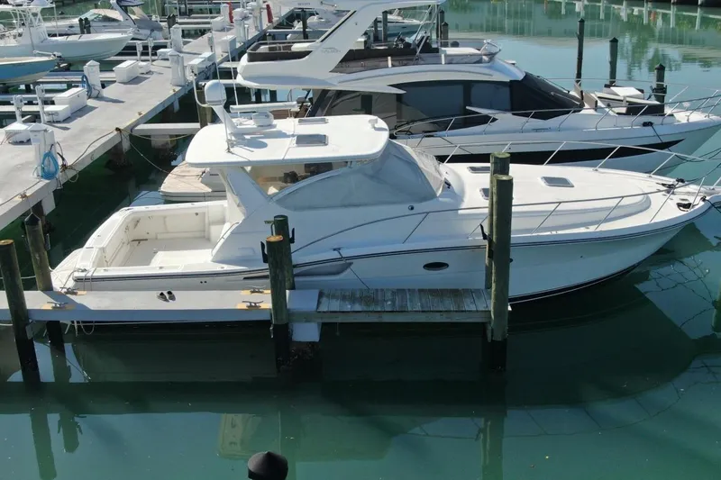 Slide: The Image of 2004 Tiara Yachts 4200 Open docked at marina, side view. - 24