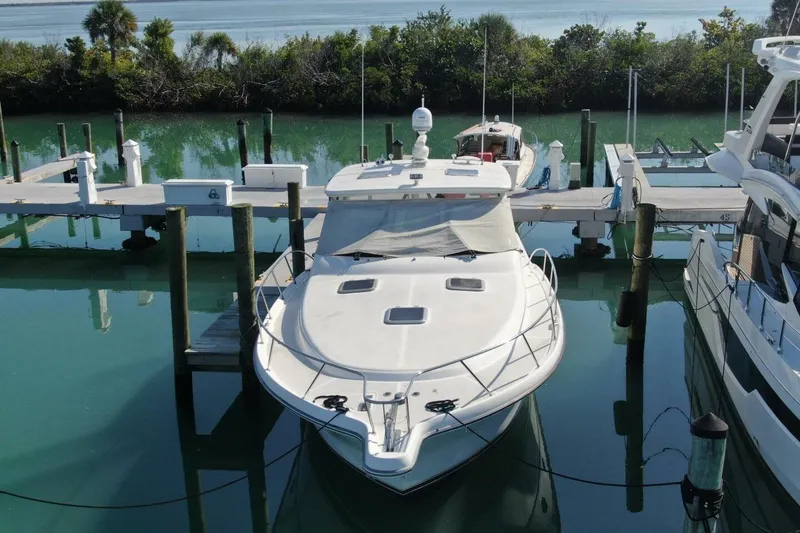 Slide: The Image of 2004 Tiara Yachts 4200 Open docked in serene marina setting. - 26