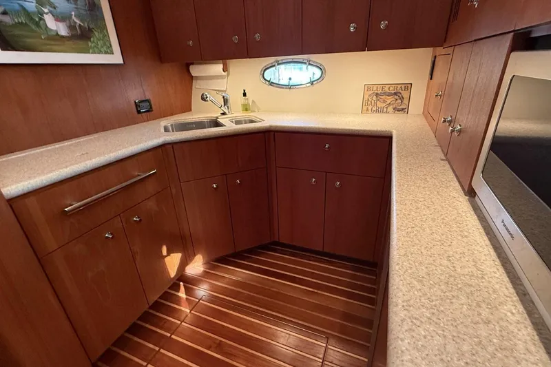 Slide: The Image of 2004 Tiara Yachts 4200 Open galley with wood cabinetry and modern appliances. - 3