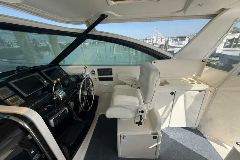 Slide: The Image of 2004 Tiara Yachts 4200 Open helm with modern controls and comfortable seating. - 5