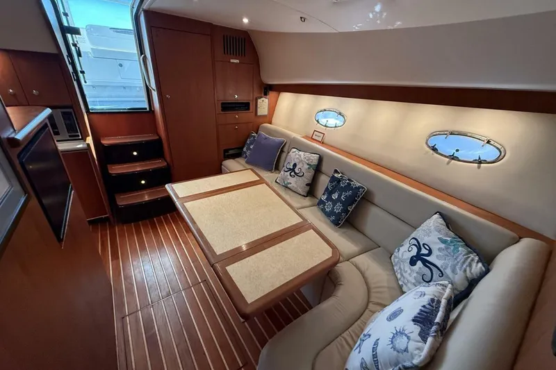 Slide: The Image of Luxurious interior of 2004 Tiara Yachts 4200 Open with elegant seating and nautical decor. - 9