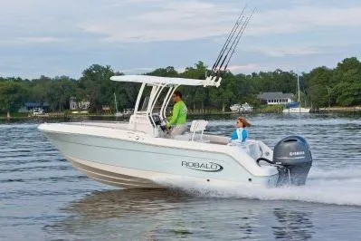 Slide: The Image of 2026 Robalo R222 Center Console boat cruising on a calm lake. - 2
