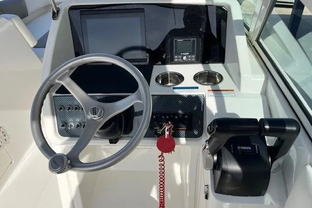 Slide: The Image of Steering console of 2021 World Cat 230 SD boat with modern controls and displays. - 4