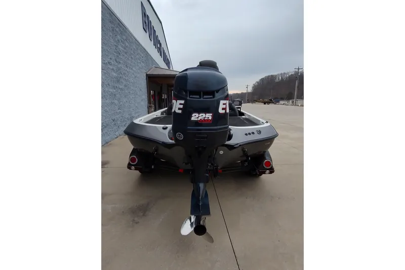 Slide: The Image of 2005 Ranger 520SVX Comanche boat with Evinrude 225 motor, parked outside dealership. - 11