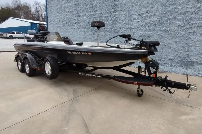 Slide: The Image of 2005 Ranger 520SVX Comanche fishing boat on trailer, parked outdoors. - 2