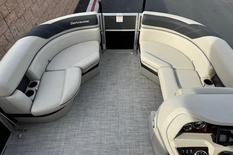 Slide: The Image of 2023 Berkshire 22RFX LE pontoon boat interior with plush seating and modern dashboard. - 10