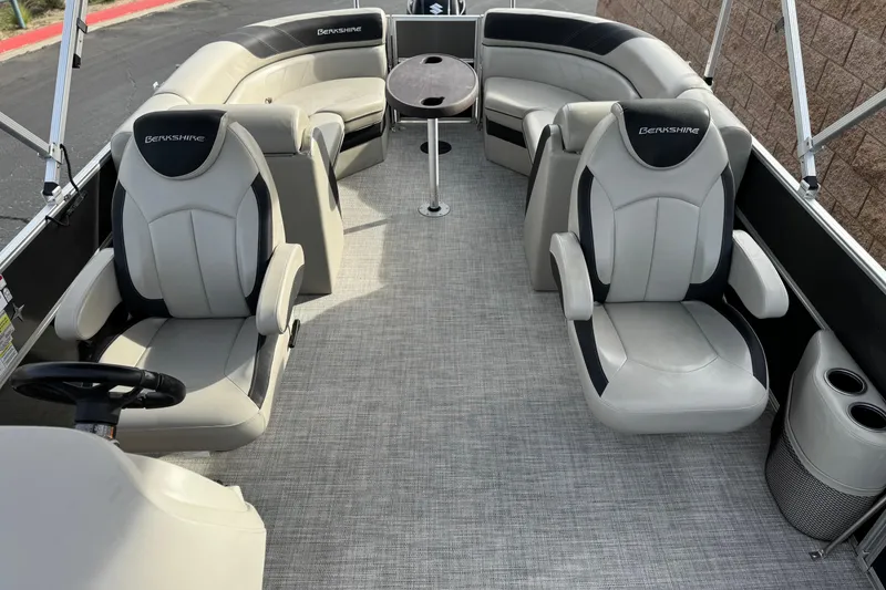Slide: The Image of 2023 Berkshire 22RFX LE pontoon boat interior with plush seating and table. - 13