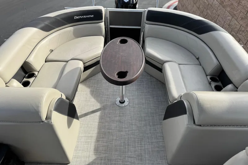Slide: The Image of 2023 Berkshire 22RFX LE boat interior with plush seating and central table. - 16