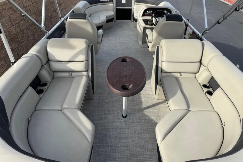 Slide: The Image of 2023 Berkshire 22RFX LE pontoon boat interior with plush seating and central table. - 21