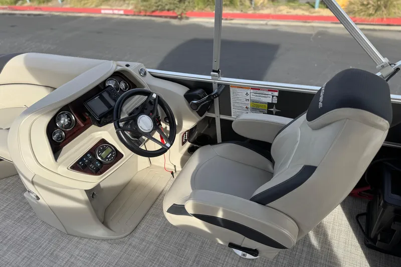 Slide: The Image of 2023 Berkshire 22RFX LE boat cockpit with steering wheel and control panel. - 22