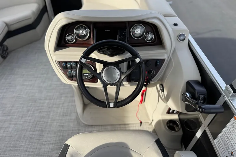 Slide: The Image of 2023 Berkshire 22RFX LE boat dashboard with steering wheel and control panel. - 23