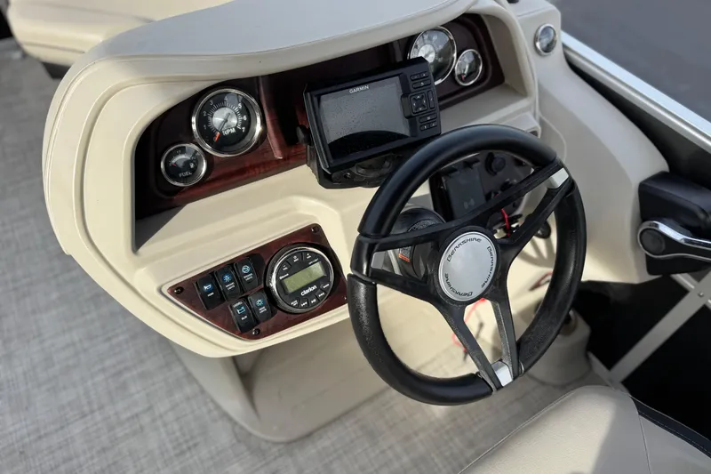 Slide: The Image of 2023 Berkshire 22RFX LE boat dashboard with steering wheel and control panel. - 24