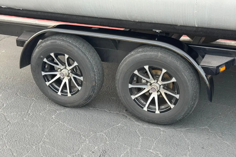 Slide: The Image of 2023 Berkshire 22RFX LE trailer wheels on asphalt surface. - 25