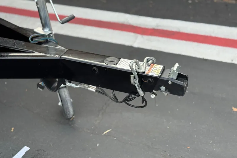 Slide: The Image of Trailer hitch of 2023 Berkshire 22RFX LE on asphalt with red and white lines. - 26