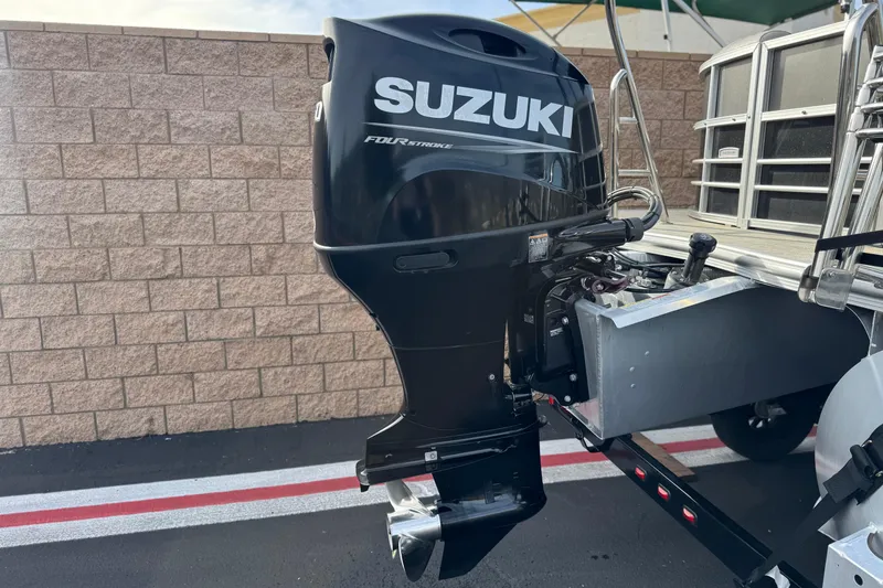 Slide: The Image of 2023 Berkshire 22RFX LE with Suzuki four-stroke outboard motor, parked near a brick wall. - 7