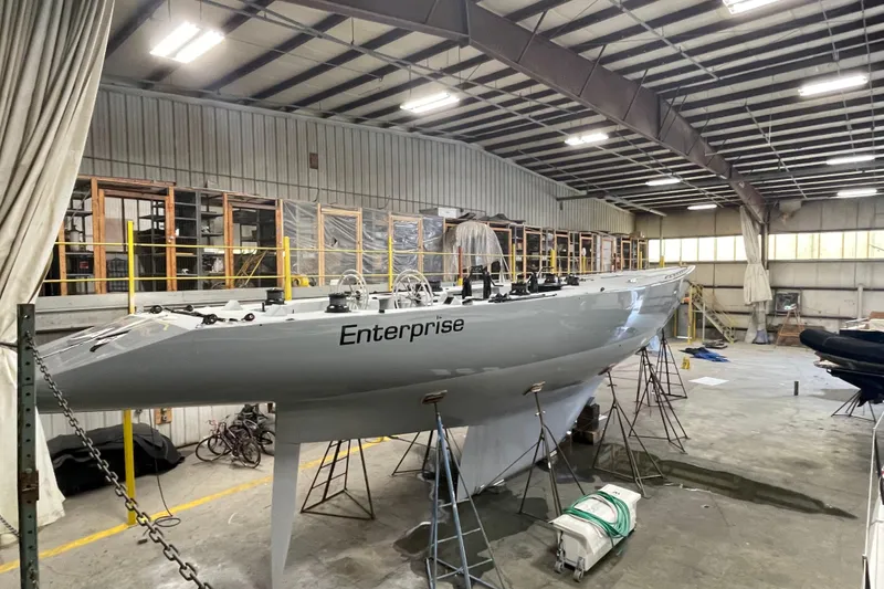 Slide: The Image of Sparkman & Stephens 12M yacht, 1997 model, named "Enterprise" in a spacious indoor facility. - 11