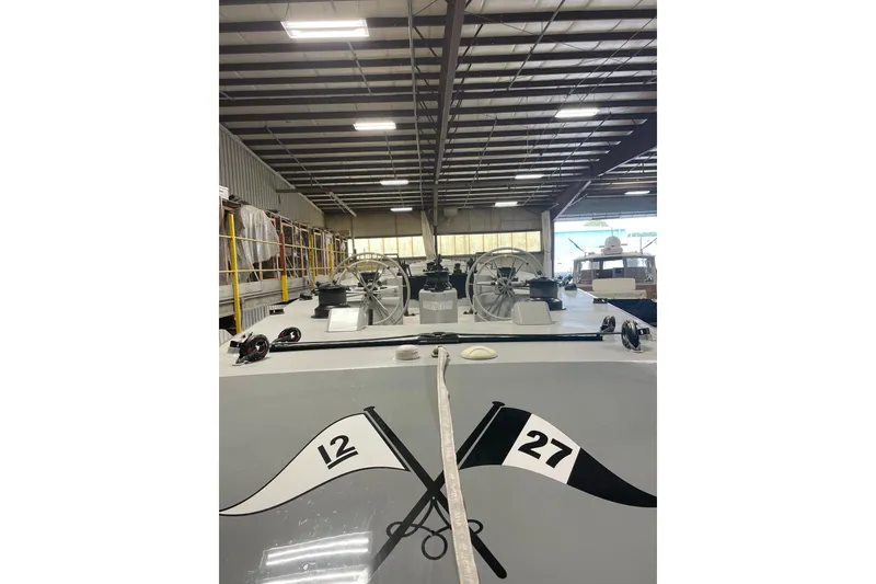 Slide: The Image of 1997 Sparkman & Stephens 12M yacht in a warehouse, showcasing deck details and equipment. - 13