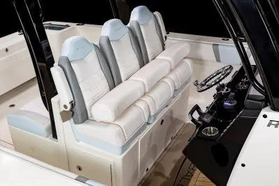 Slide: The Image of 2026 Robalo R360 Center Console boat interior with plush seating and modern helm controls. - 15