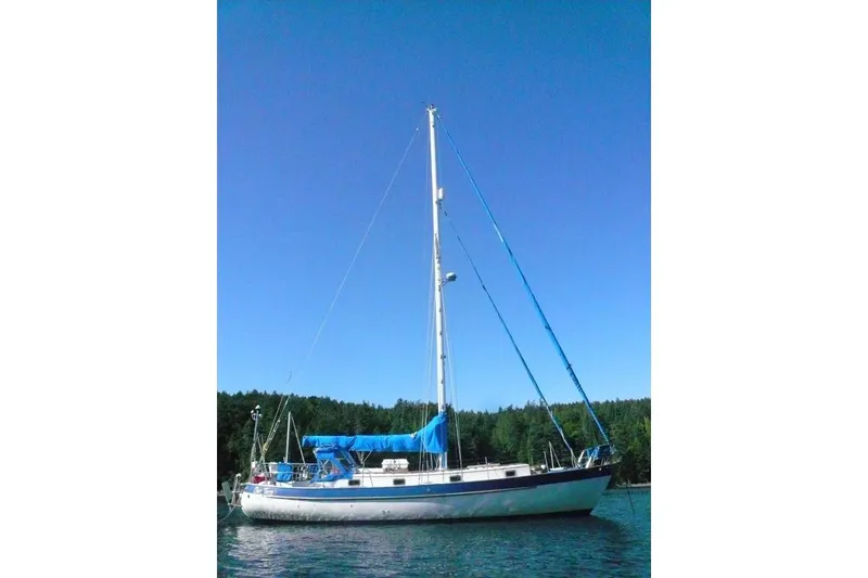 The Image of 1977 Valiant 40 sailboat on calm water under clear blue sky. - 0
