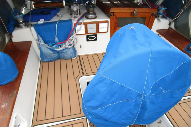 Slide: The Image of 1977 Valiant 40 sailboat cockpit with blue covers and wooden accents. - 10